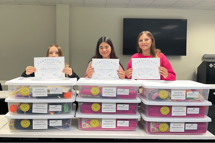 Girl Scouts of Gulfcoast Florida Earn Highest Award for Bringing Comfort to Kids in Medical Crisis Sarasota & Charlotte County, FL – Three dedicated Girl Scout Cadettes from Troop 608 have earned the prestigious Girl Scout Silver Award—the highest award a Girl Scout Cadette can achieve—for creating and delivering sensory kits to children experiencing medical emergencies across Charlotte and South Sarasota Counties. Addison B., Emma V., and Brinley E. identified a critical gap in care: while sensory kits were available in shelters, EMS units, and hospital emergency rooms through the Southwest Florida Healthcare Coalition, they were not available in local free-standing emergency departments or walk-in clinics—facilities where many families first seek care. Their Take Action project, “Sensory Kits for Kids in Distress,” provided nine fully stocked sensory kits to three free-standing departments and six walk-in clinics serving their community in Sarasota and Manatee County.